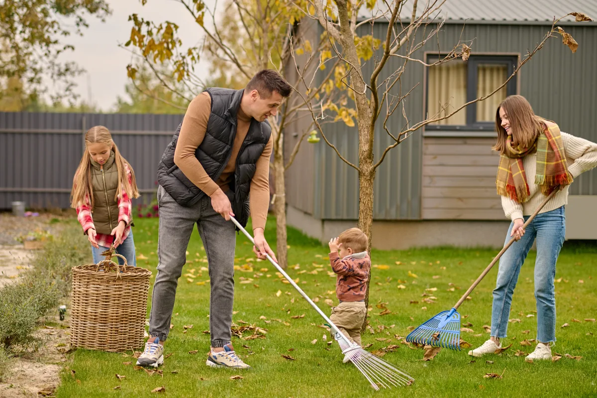 Family raking leaves together as an outdoor chore