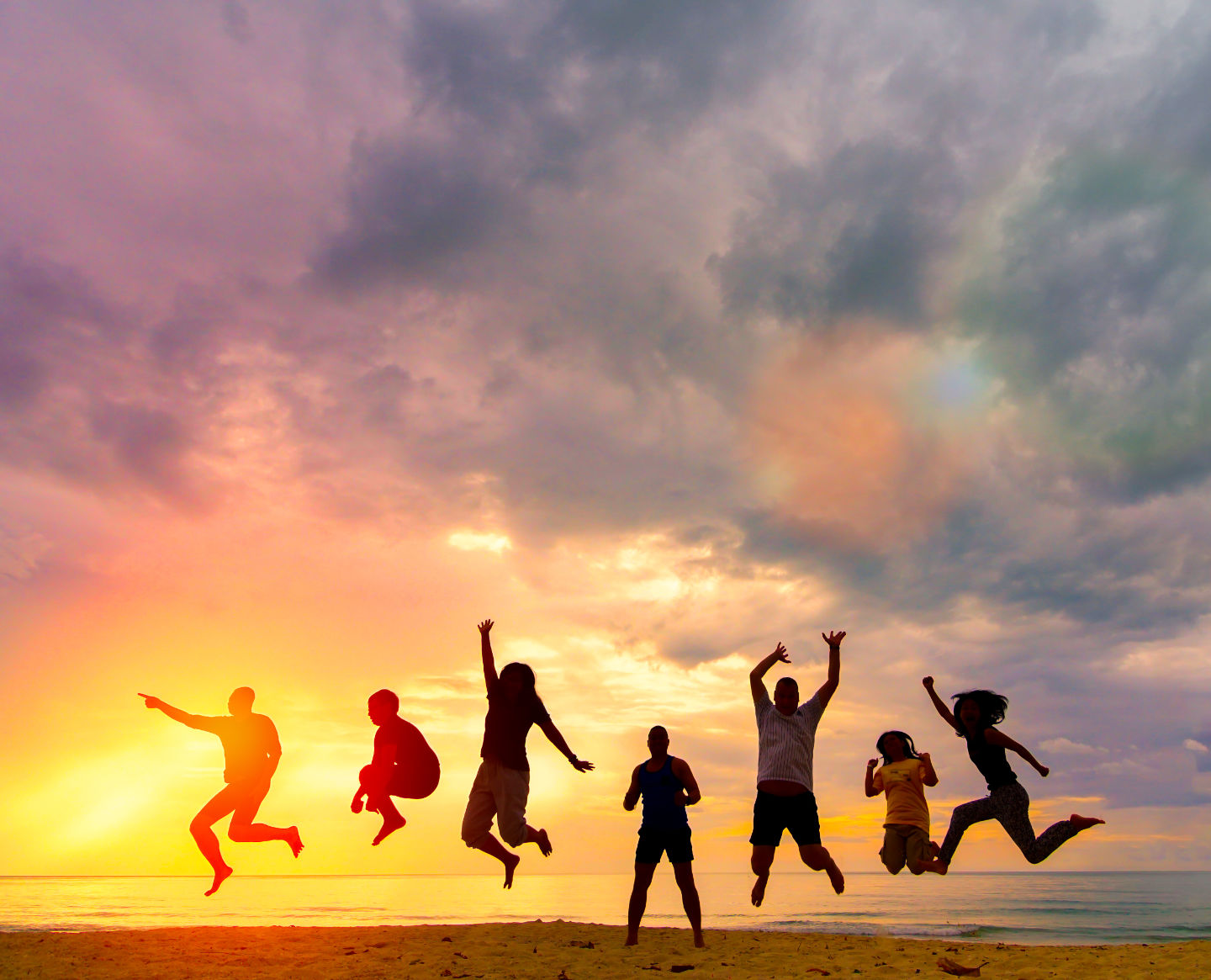 Family jumping at sunset