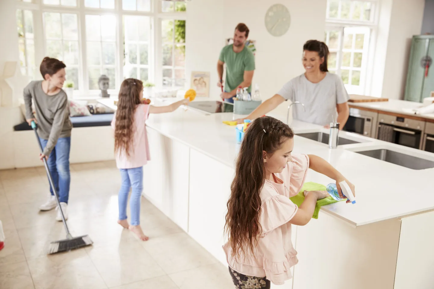 Family cleaning the kitchen together as part of their chore routine
