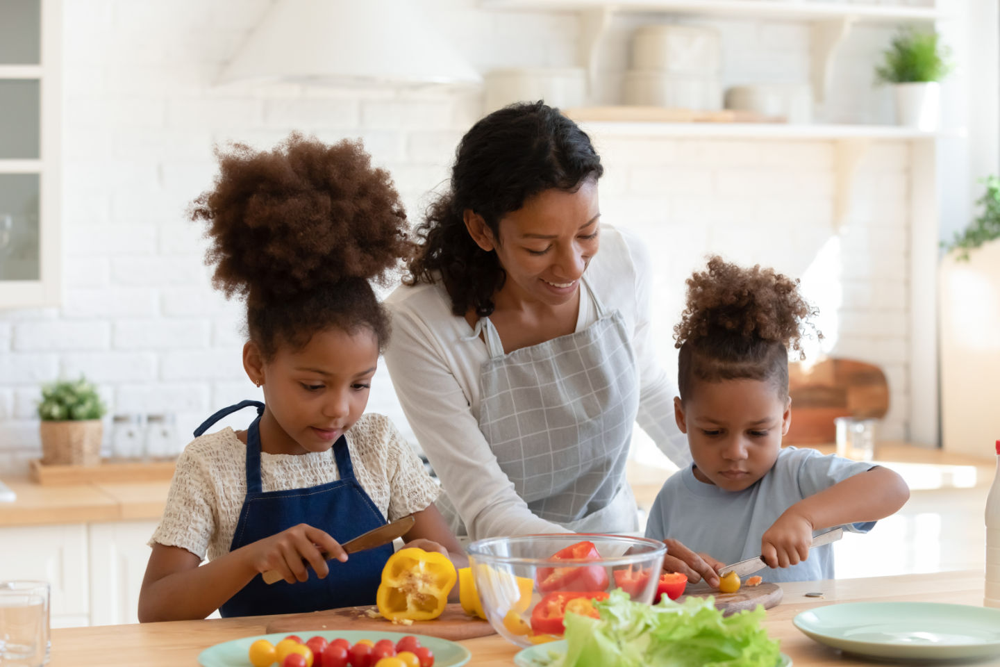 Mom cooking with kids in the kitchen