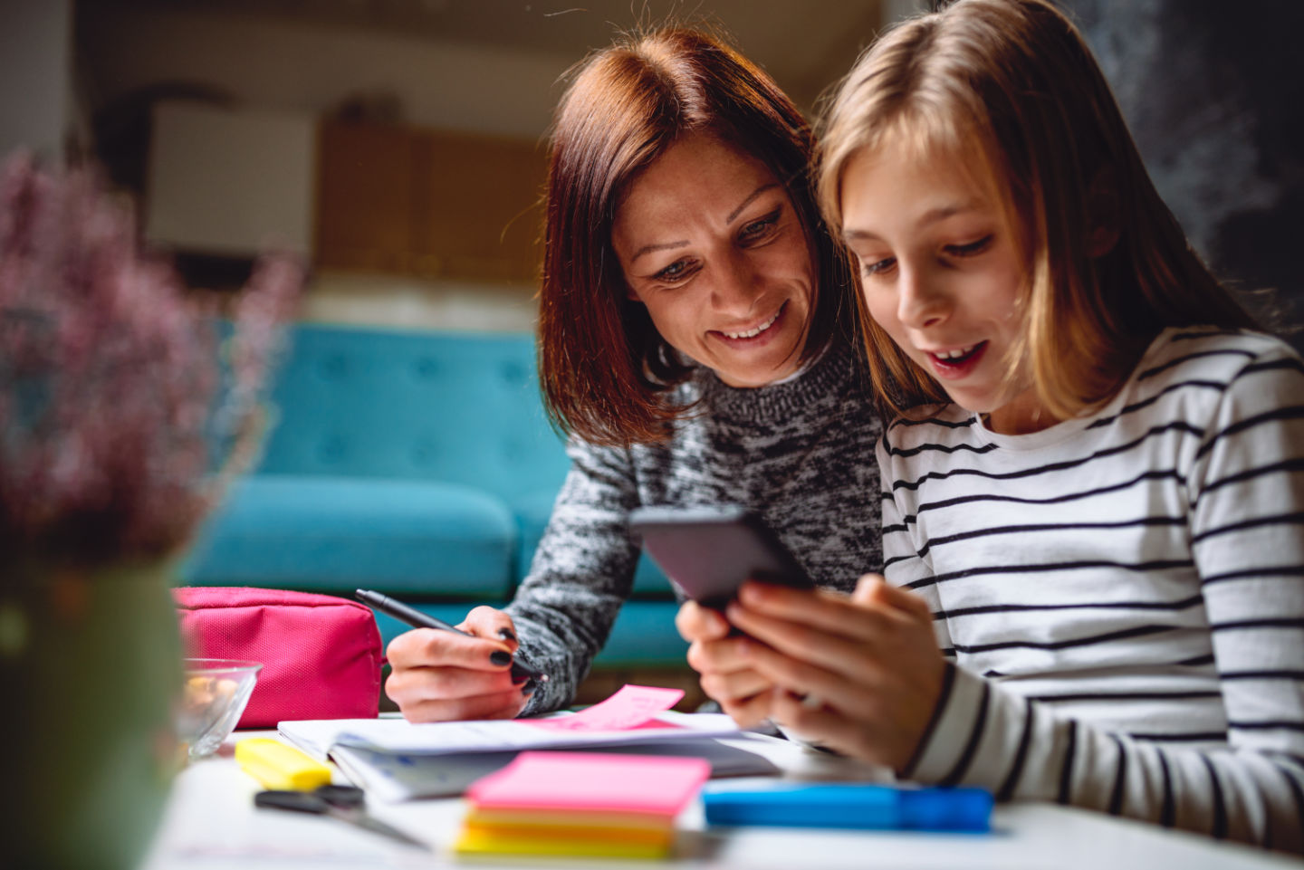 Mother and daughter looking at phone together